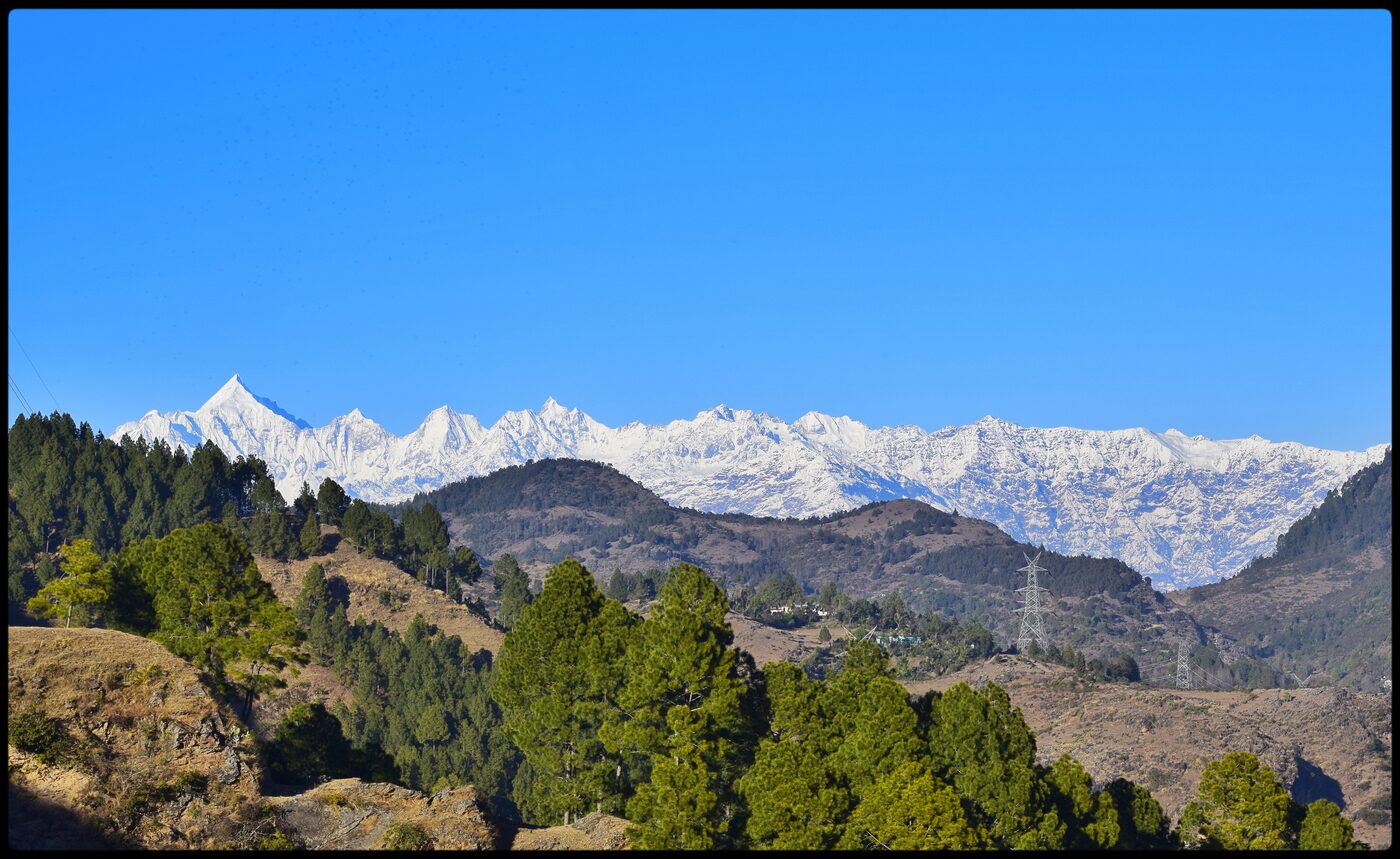 The five snow-capped Panchachuli peaks glowing at sunrise above the Haat Valley.